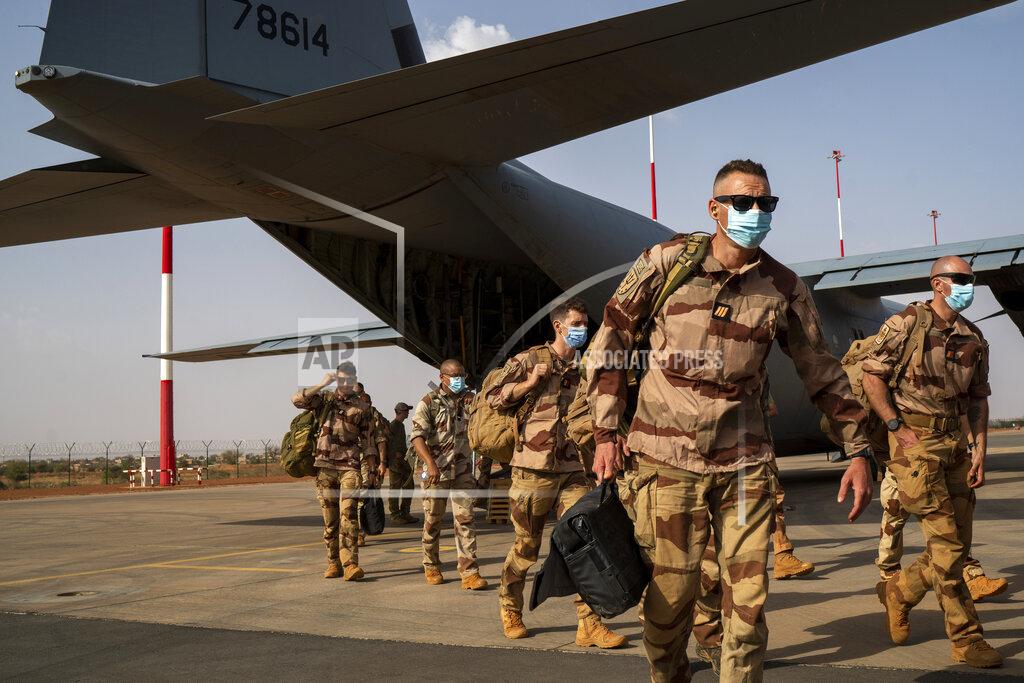Uncredited French Barkhane soldiers arriving from Gao, Mali, disembark from a US Air Force C130 cargo plane at Niamey, Niger base Wednesday June 9, 2021, before transferring back to their Bases in France. French President Emmanuel Macron announced at a press conference Thursday June 10, 2021 That operation Barkhane would end and be replaced by support for local partners and counter terrorism. (AP Photo/Jerome Delay)