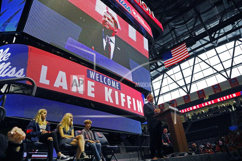 Rogelio V. Solis Lane Kiffin, right, speaks to Mississippi fans after being announced as the new NCAA college football coach during a public introduction at The Pavilion, a multipurpose arena on the campus in Oxford, Miss., Monday, Dec. 9, 2019. In attendance were his children, daughters Presley Kiffin, 13, left, Landry Kiffin, 15, second from left, and son Knox Kiffin, 10. Kiffin was previously, the football coach for three years at Florida Atlantic. (AP Photo/Rogelio V. Solis)
