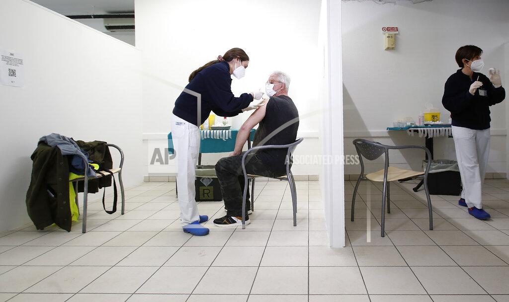 Antonio Calanni FILE - In this Friday, April 9, 2021 filer photo, medical staff members administer shots of Russia's Sputnik V vaccine for COVID-19, at the San Marino State Hospital, in San Marino. The tiny Republic of San Marino on Wednesday announced a plan to offer vaccines to tourists, on the heels of its successful vaccination campaign with the Russian Sputnik V. Under the plan, tourists can get vaccinated as long as they reserve two stays of at least three nights, with the second coming three to four weeks after the first for the second jab. The program launches on Monday. (AP Photo/Antonio Calanni, File)