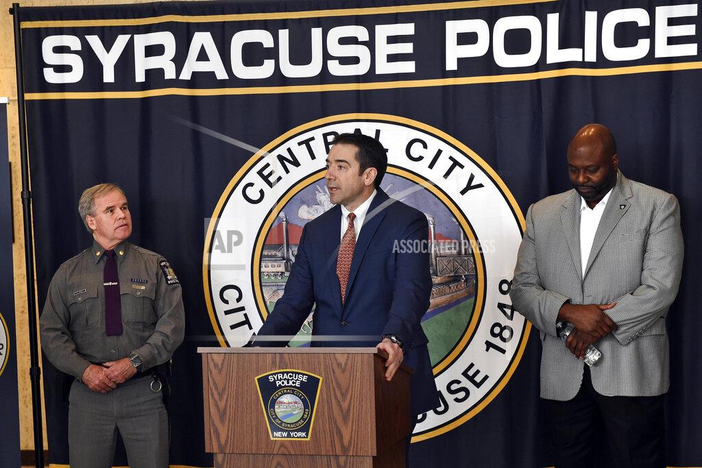 Peter Fitzgerald from the FBI addresses questions about a series of racist messages and hate crimes that have occurred at SU in the last two weeks during a press conference Tuesday, Nov. 19, 2019, at the Public Safety Building in Syracuse, N.Y. On the far left is Syracuse University DPS Chief Bobby Maldonado. Next to him is Major Philip Rougeux, Troop D Commander for the New York State Police. At right is Syracuse Police Chief Kenton Buckner. (Lauren Long/The Syracuse Newspapers via AP)
