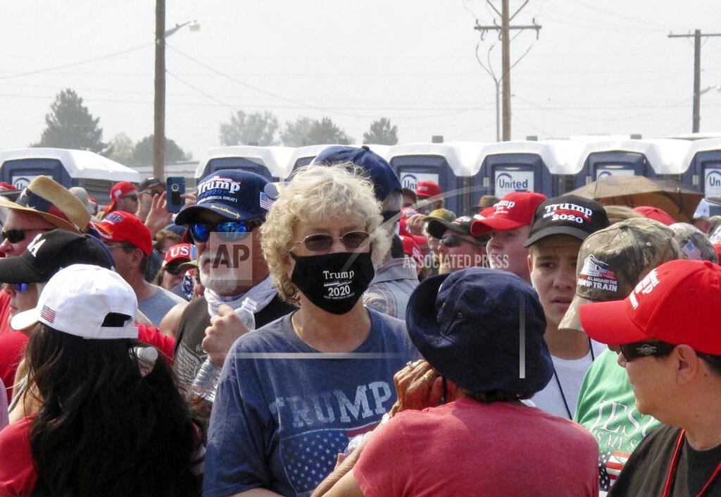 Scott Sonner People line up outside the gates three hours before President Donald Trump is scheduled to speak Saturday night at a campaign rally at Minden-Tahoe Airport under smoky skies from California wildfires along the Sierra Nevada's eastern front in Minden, Nev., Saturday, Sept. 12, 2020 (AP Photo/Scott Sonner)