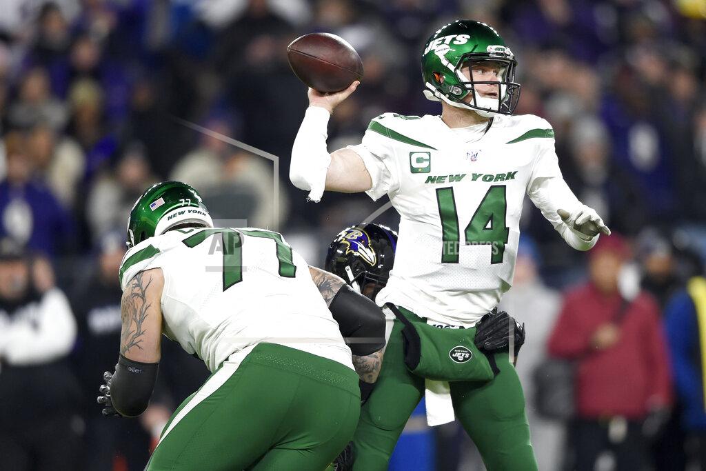 Gail Burton New York Jets quarterback Sam Darnold (14) throws a pass as Baltimore Ravens defensive end Jihad Ward, center, grabs at him during the first half of an NFL football game, Thursday, Dec. 12, 2019, in Baltimore. (AP Photo/Gail Burton)