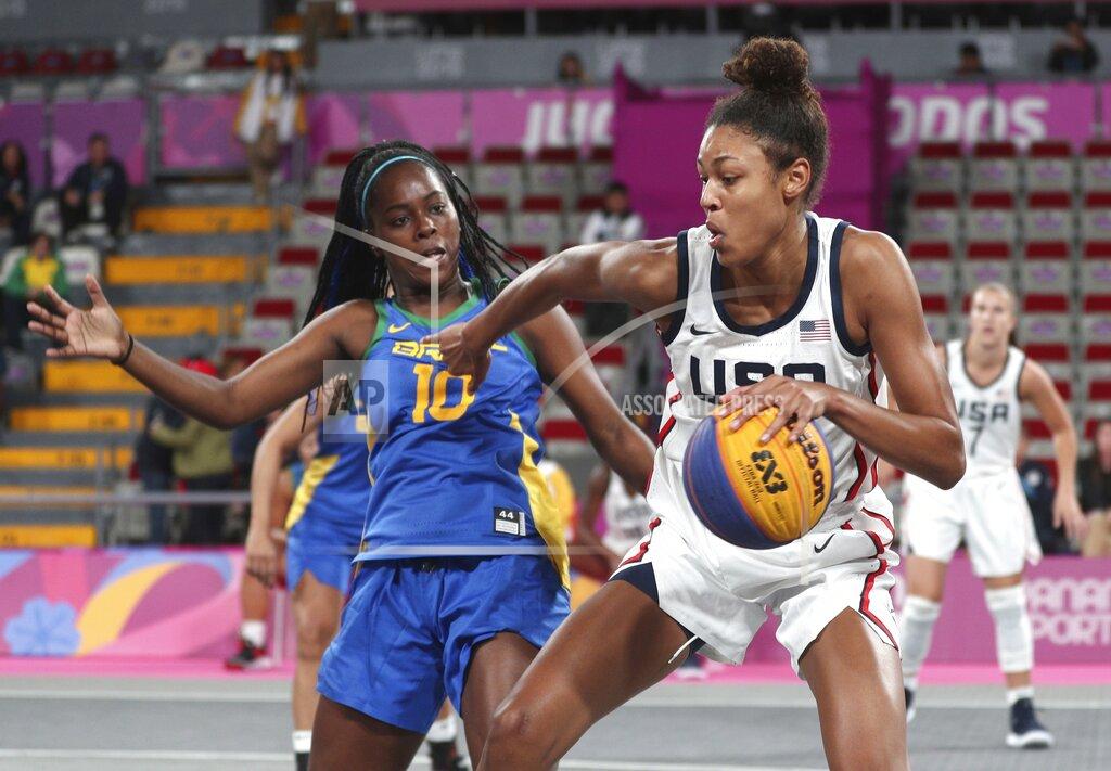 FILE - In this July 29, 2019, file photo, Olivia Nelson, right, of the United States, drives around Evelyn Mariano, of Brazil, during the women's basketball 3x3 semifinal match at the Pan American Games in Lima, Peru. The Olympics website calls 3x3 basketball “exciting, urban and innovative.” It was added to the program for Tokyo to lure a younger audience and get more countries involved in one of the core sports of the Olympic Games. (AP Photo/Martin Mejia, File)