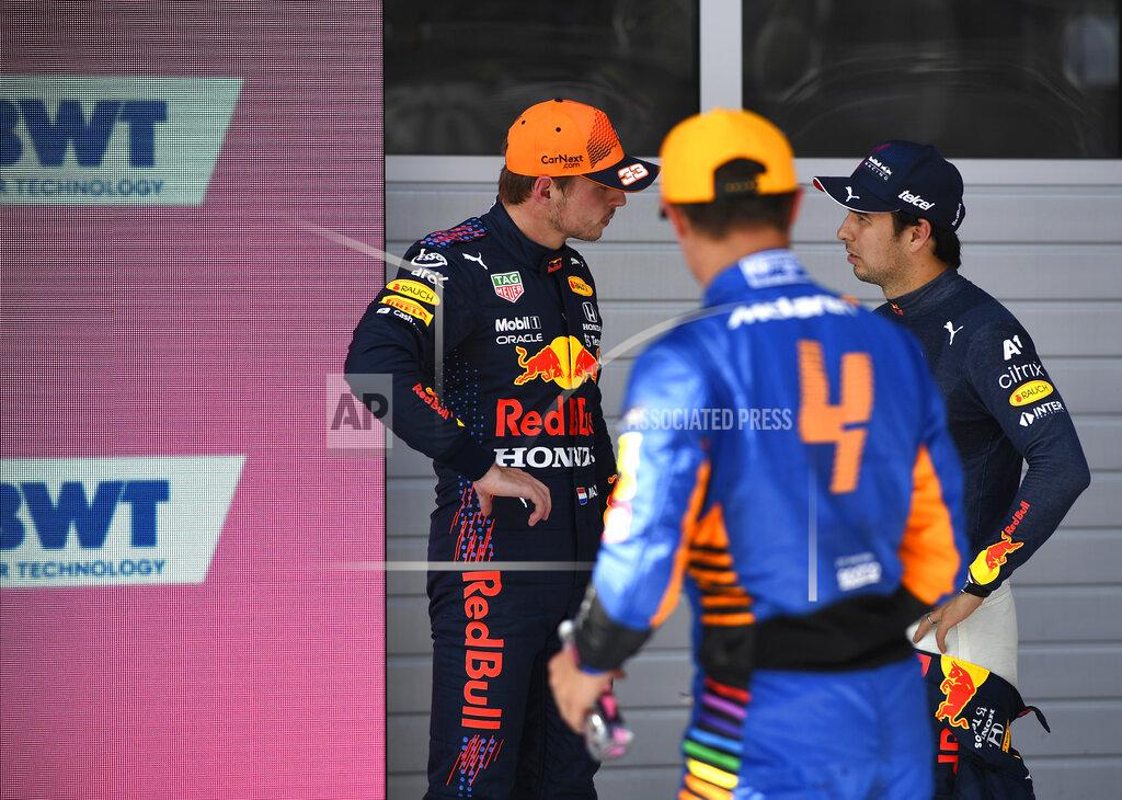 First place for pole position, Red Bull driver Max Verstappen of the Netherlands, left, speaks with third place, Red Bull driver Sergio Perez of Mexico, right, after the qualifying session ahead of the Austrian Formula One Grand Prix at the Red Bull Ring racetrack in Spielberg, Austria, Saturday, July 3, 2021. The Austrian Grand Prix will be held on Sunday. (Christian Bruna/Pool Photo via AP)