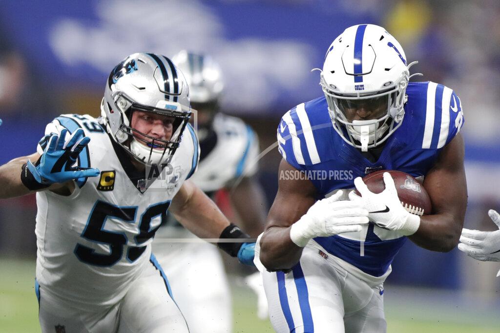 Michael Conroy FILE - In this Dec. 22, 2019, file photo, Carolina Panthers' Luke Kuechly (59) charges Indianapolis Colts running back Marlon Mack (25) during the first half of an NFL football game in Indianapolis. The Panthers will look to upgrade their defense in the NFL draft after losing nine starters from last year’s unit, including five-time All-Pro linebacker Kuechly. (AP Photo/Michael Conroy, File)