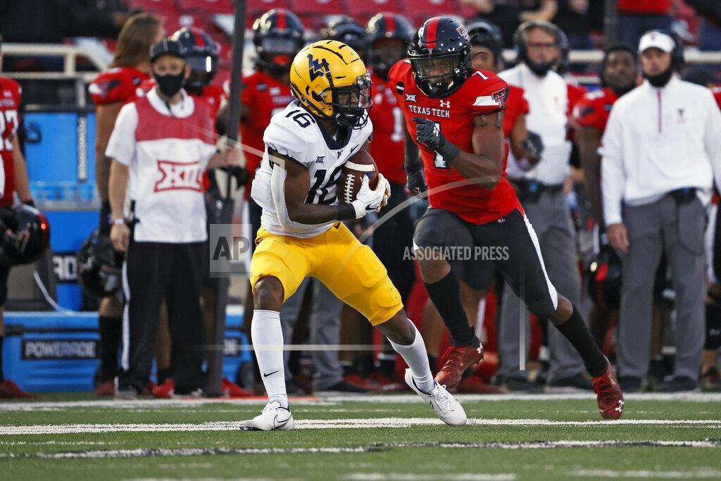 Brad Tollefson West Virginia's Winston Wright Jr. (16) catches a pass during the second half of an NCAA college football game against Texas Tech, Saturday, Oct. 24, 2020, in Lubbock, Texas. (AP Photo/Brad Tollefson)