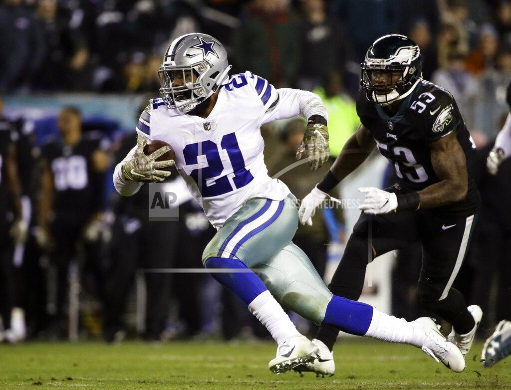 Matt Rourke FILE - In this Nov. 11, 2018, file photo, Dallas Cowboys running back Ezekiel Elliott (21) runs against the Philadelphia Eagles during an NFL football game in Philadelphia. The Dallas Cowboys have picked up the fifth-year option on Ezekiel Elliott's rookie contract, keeping the star running back with the club at least through 2020. The two-time NFL rushing champion is set to make $3.9 million this season and $9.1 million in his fifth year unless Elliott and the team agree on a contract before then. The Cowboys have said they want a long-term deal with the fourth overall pick from the 2016 draft. (AP Photo/Matt Rourke, File)