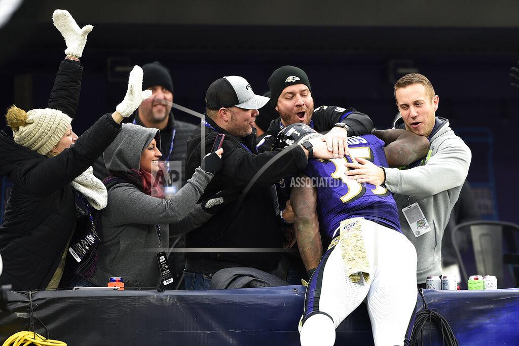 Gail Burton Baltimore Ravens running back Gus Edwards jumps onto fans after running for a touchdown against the Houston Texans during the second half of an NFL football game, Sunday, Nov. 17, 2019, in Baltimore. (AP Photo/Gail Burton)