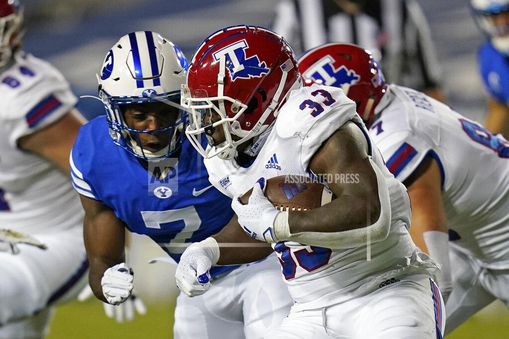 Rick Bowmer Louisiana Tech running back Justin Henderson (33) carries the ball as BYU defensive back George Udo (7) closes in for the tackle during the first half of an NCAA college football game Friday, Oct. 2, 2020, in Provo, Utah. (AP Photo/Rick Bowmer, Pool)