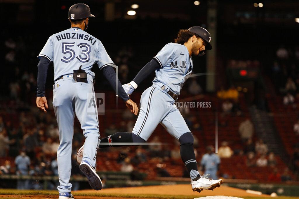 Winslow Townson Toronto Blue Jays' Bo Bichette is congratulated by first base coach Mark Budzinski after hitting a solo home run during the fourth inning of a baseball game against the Boston Red Sox Tuesday, April 20, 2021, at Fenway Park in Boston. (AP Photo/Winslow Townson)