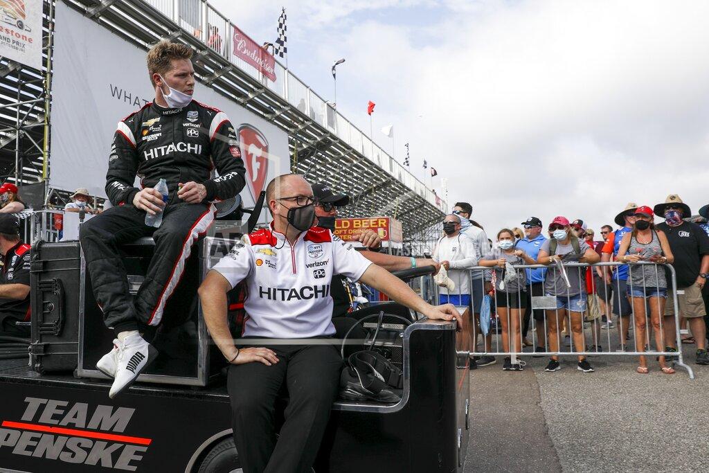 Ivy Ceballo Team pence driver Josef Newgarden, left, exits the track at the Grand Prix of St. Petersburg auto race, Sunday, April 25, 2021 in St. Petersburg, Fla. (Ivy Ceballo/Tampa Bay Times via AP)