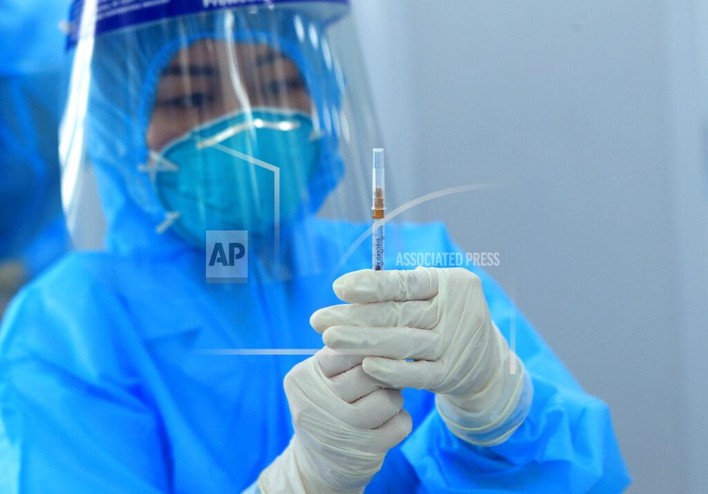 Hau Dinh A health worker prepares a dose of AstraZeneca COVID-19 vaccine at Hospital for Tropical Diseases in Hanoi, Vietnam Monday, March 8, 2021. Vietnam has started the vaccination campaign with a hope to inoculate half of the population of 96 millions against COVID-19 by the end of the year. (AP Photo/Hau Dinh)