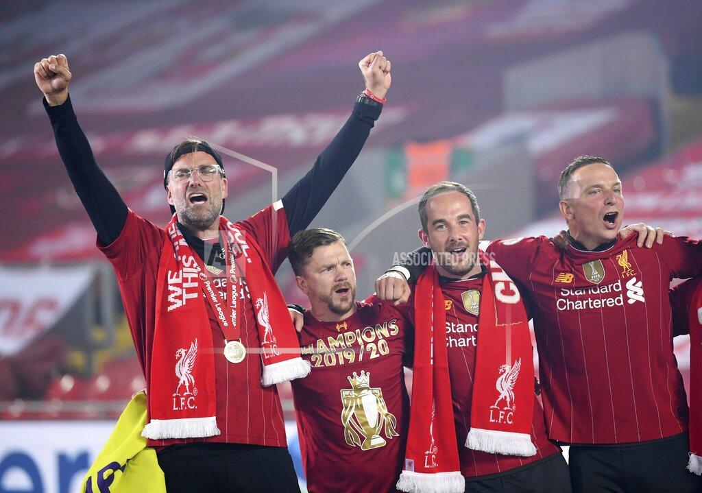 Laurence Griffiths Liverpool's manager Jurgen Klopp, left, celebrates following the English Premier League soccer match between Liverpool and Chelsea at Anfield Stadium in Liverpool, England, Wednesday, July 22, 2020. Liverpool are champions of the EPL for the season 2019-2020. The trophy is presented at the teams last home game of the season. Liverpool won the match against Chelsea 5-3. (Laurence Griffiths, Pool via AP)