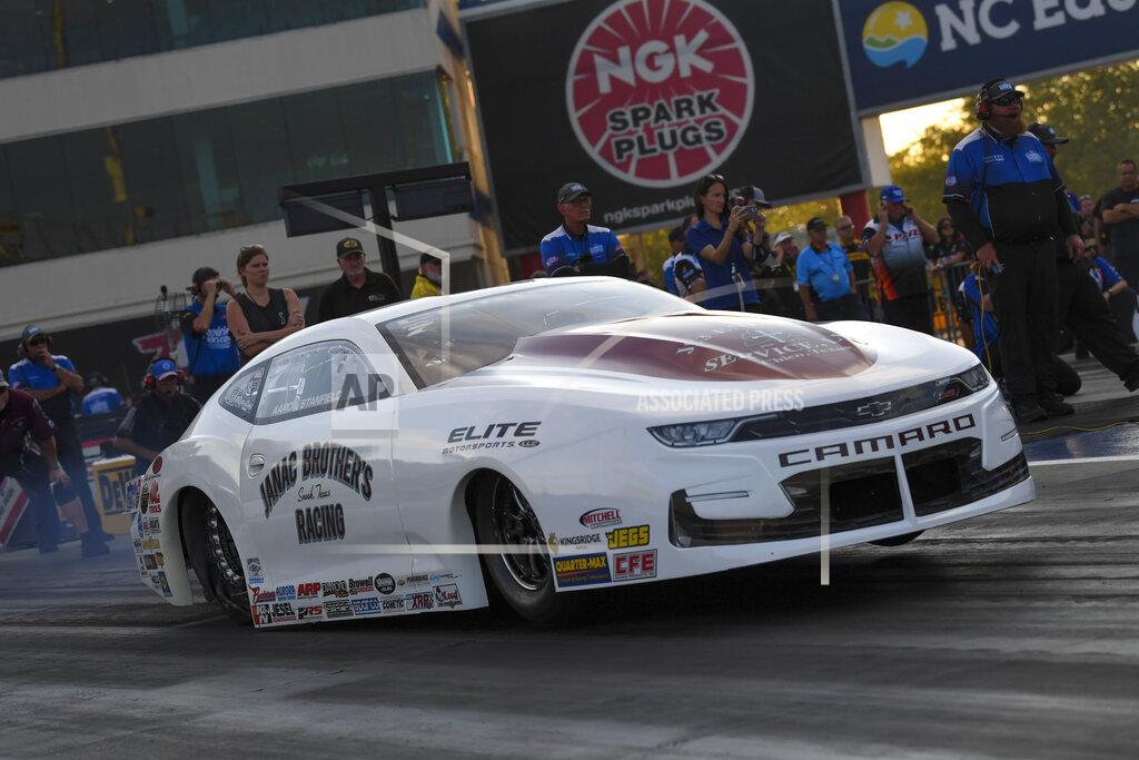 Richard H Shute In this photo provided by the NHRA, Pro Stock's Aaron Stanfield races to the provisional No. 1 position in his first-round qualifying run in his Janac Brothers Chevrolet Camaro at the DeWalt NHRA Carolina Nationals at zMAX Dragway in Concord, N.C., Friday, Sept. 17, 2021. (Richard H. Shute/NHRA via AP)