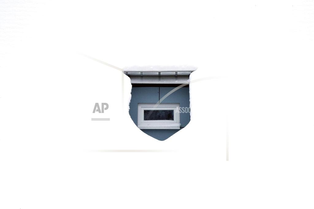 Matthias Schrader A window of a house is completely surrounded by snow in Altenberg, Germany, Friday, Feb.12, 2021. (AP Photo/Matthias Schrader)