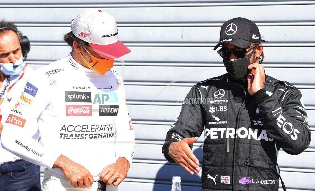 Jennifer Lorenzini Mercedes driver Lewis Hamilton, right, of Britain, talks with third placed Mclaren driver Carlos Sainz, of Spain, after clocking the fastest time during the qualifying session for Sunday's Italian Formula One Grand Prix, at the Monza racetrack in Monza, Italy, Saturday, Sept. 5, 2020. (Jennifer Lorenzini/Pool via AP)