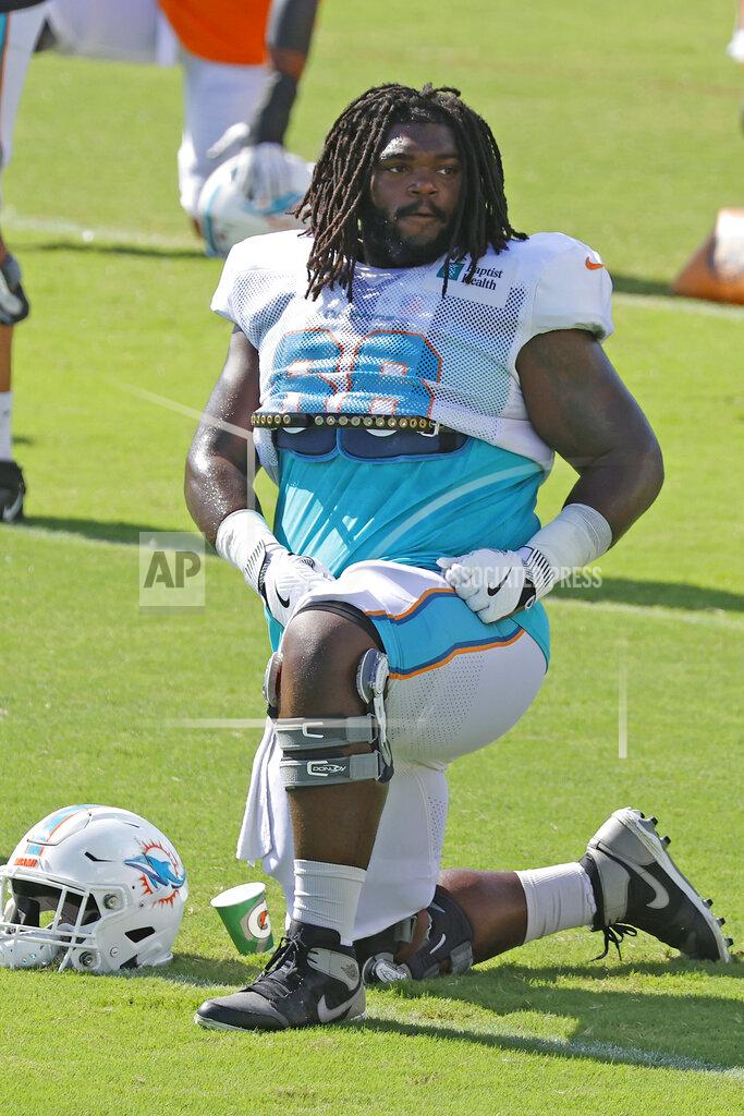 Joel Auerbach FILE - Miami Dolphins guard Solomon Kindley (66) stretches prior to an NFL football training camp practice in Davie, Fla., Tuesday, Aug. 18, 2020. At least four Miami Dolphins rookies are expected to see significant action in Sunday’s, Sept. 13 opener. Left tackle Austin Jackson and right guard Solomon Kindley won starting jobs in training camp. (AP Photo/Joel Auerbach, File)