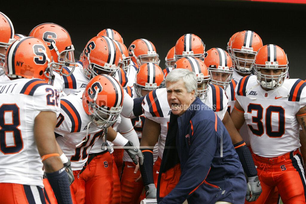 Al Behrman FILE - Syracuse head coach Greg Robinson leads his team onto the field against Cincinnati in an NCAA college football game, Saturday, Nov. 29, 2008, in Cincinnati. It was the last game at Syracuse for Robinson. Greg Robinson, who spent nearly four decades coaching in the NFL and college, has died at 70. His wife Laura confirmed that he died on Wednesday, Jan. 5, 2022, from a form of Alzheimer's Disease. (AP Photo/Al Behrman, File)