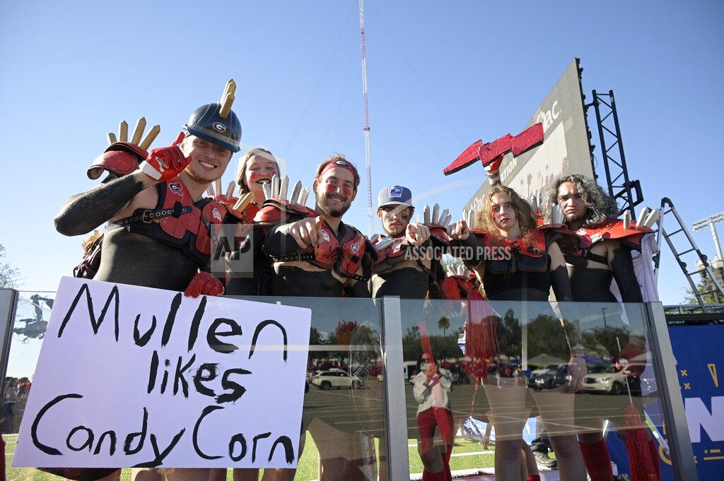 Phelan M. Ebenhack Georgia fans show their costumes outside the stadium before an NCAA college football game against Florida, Saturday, Oct. 30, 2021, in Jacksonville, Fla. (AP Photo/Phelan M. Ebenhack)