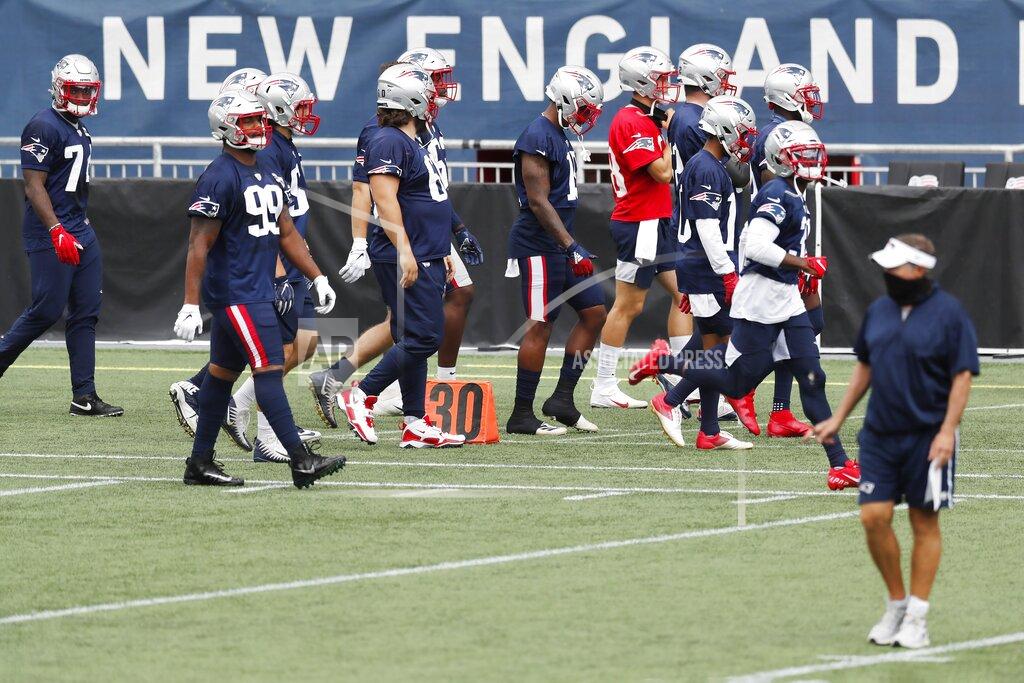 Michael Dwyer New England Patriots players take the field before an NFL football training camp scrimmage, Friday, Aug. 28, 2020, in Foxborough, Mass. Head coach Bill Belichick is at right. (AP Photo/Michael Dwyer, Pool)