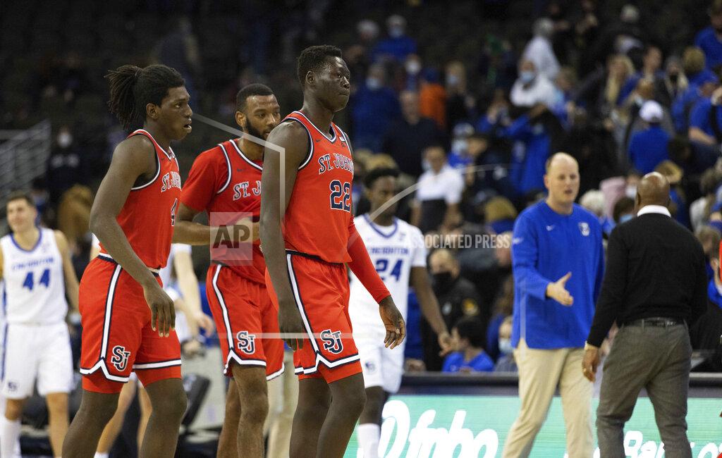 Rebecca S. Gratz From left, St. John's O'Mar Stanley, Aaron Wheeler and Esahia Nyiwe (22) exit the court following their 87-64 loss to Creighton in an NCAA college basketball game Wednesday, Jan. 19, 2022, in Omaha, Neb. (AP Photo/Rebecca S. Gratz)