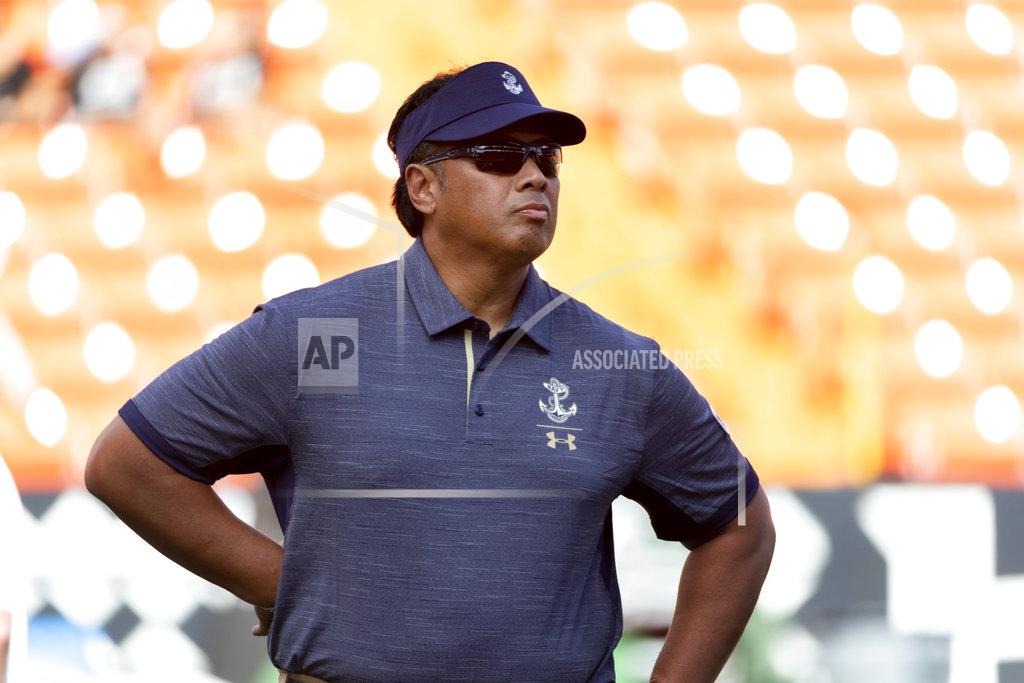 File-This Sept. 1, 2018, file photo shows Navy head coach Ken Niumatalolo looking on as his team warms up before an NCAA college football game in Honolulu. Navy has one of the most productive running attacks in the nation, ranking third behind Georgia Teach and Army at 286.9 yards per game. The bad news is the Midshipmen are coming off being held to a season-low 124 yards on the ground in the 42-0 loss to Cincinnati. “We've never been beat like that,'' Niumatalolo said. (AP Photo/Eugene Tanner, File)
