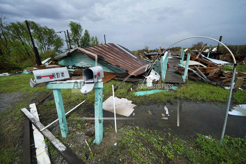 Gerald Herbert Storm clouds from Tropical Storm Nicholas are seen behind homes of the vanishing Native American community of Isle de Jean Charles, La., which were destroyed by Hurricane Ida, Tuesday, Sept. 14, 2021. (AP Photo/Gerald Herbert)