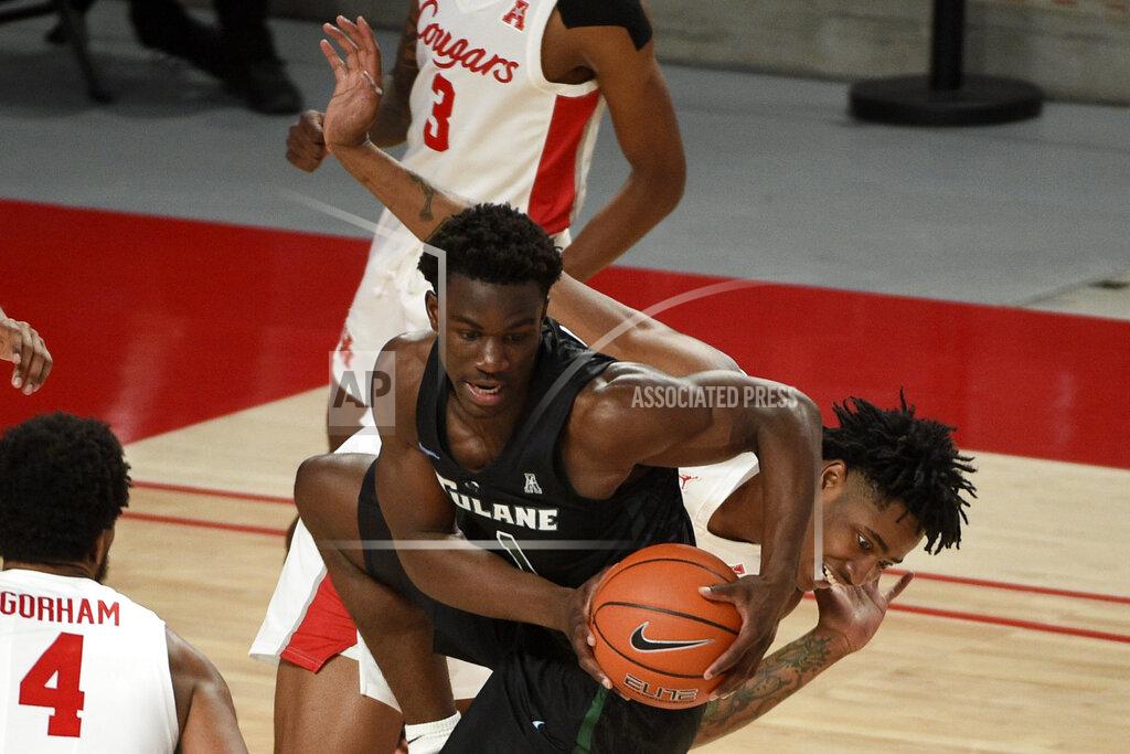 Eric Christian Smith Tulane guard Sion James (1) grabs the ball away from Houston forward Brison Gresham, right, during the second half of an NCAA college basketball game, Saturday, Jan. 9, 2021, in Houston. (AP Photo/Eric Christian Smith)