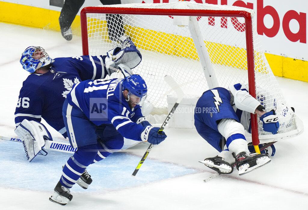 Nathan Denette Tampa Bay Lightning forward Nicholas Paul (20) crashes into Toronto Maple Leafs goaltender Jack Campbell (36) as Maple Leafs forward Colin Blackwell (11) defends during the third period of Game 7 in an NHL hockey first-round playoff series in Toronto, Saturday, May 14, 2022. (Nathan Denette/The Canadian Press via AP)