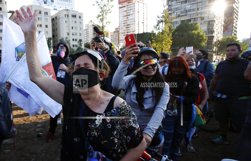 Luis Hidalgo People gather at Plaza Italia on the day Chileans voted in a referendum to decide whether the country should replace its 40-year-old constitution, written during the dictatorship of Gen. Augusto Pinochet, in Santiago, Sunday, Oct. 25, 2020. (AP Photo/Luis Hidalgo)