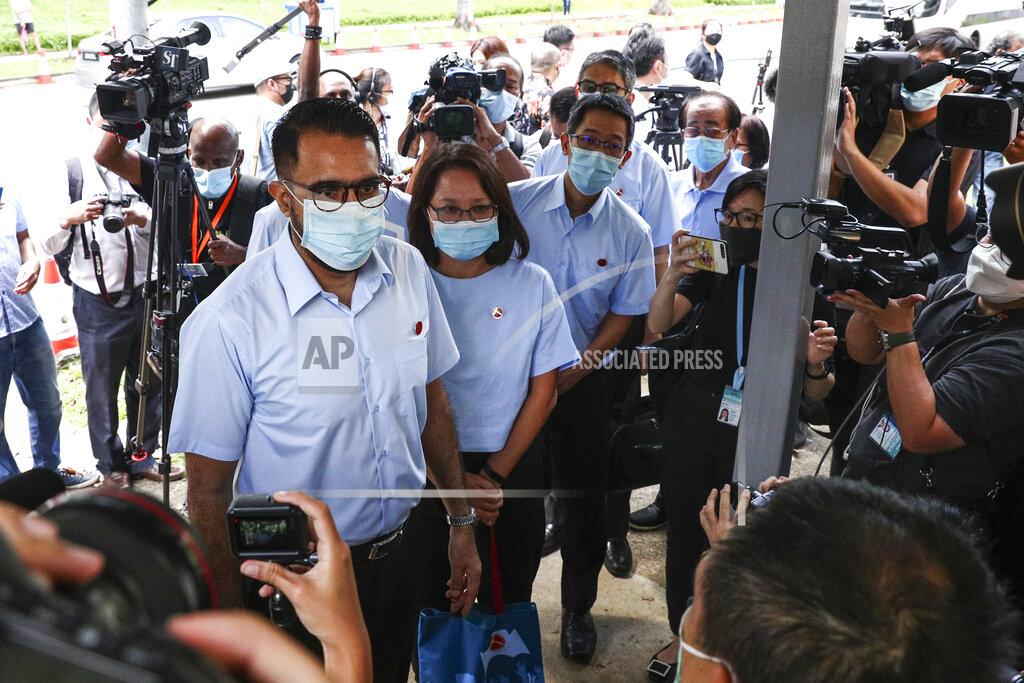 Yong Teck Lim Workers' Party Secretary-General Pritam Singh, left, and Chairman Sylvia Lim, second left, arrive at a nomination center with their team to submit their nomination papers ahead of the general election in Singapore, Tuesday, June 30, 2020. Campaigning has begun for Singapore’s general elections, with the opposition hoping to dent the ruling party’s supermajority in parliament. (AP Photo/Yong Teck Lim)