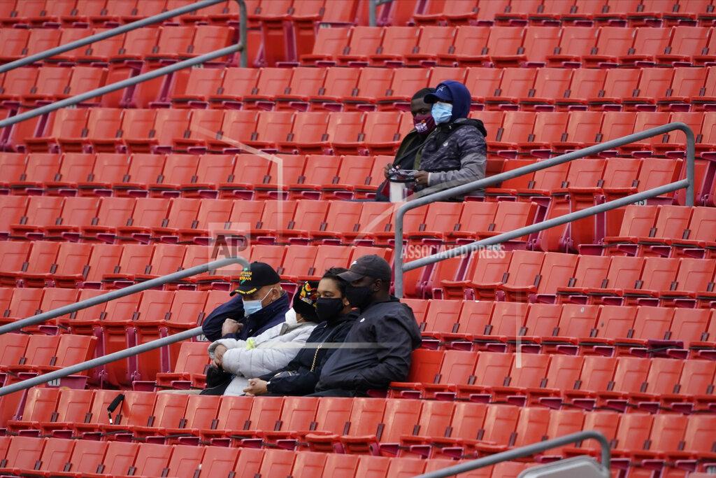 Susan Walsh Fans sits and watch the first half of an NFL football game between the Dallas Cowboys and Washington Football Team, Sunday, Oct. 25, 2020, in Landover, Md. (AP Photo/Susan Walsh)