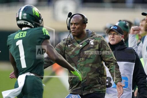 Michigan State head coach Mel Tucker greets wide receiver Jayden Reed (1) after a touchdown during the first half of an NCAA college football game against Maryland, Saturday, Nov. 13, 2021, in East Lansing, Mich. (AP Photo/Carlos Osorio)