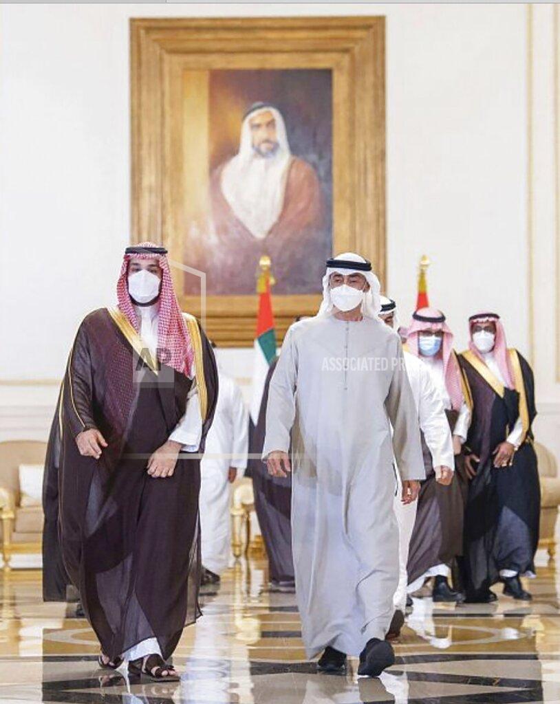 Uncredited In this photo released by Saudi Press Agency, Saudi Crown Prince Mohammed bin Salman, left, arrives in Abu Dhabi to offer condolences to Sheikh Mohamed bin Zayed Al Nahyan, president of the UAE and ruler of Abu Dhabi, third, right, on the passing of Sheikh Khalifa bin Zayed Al Nahyan, the late president of the UAE, at the Presidential Airport in Abu Dhabi, UAE, Monday, May 16, 2022. (Saudi Press Agency via AP)