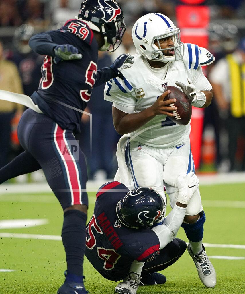 David J. Phillip Indianapolis Colts quarterback Jacoby Brissett (7) is pressured by Houston Texans outside linebacker Whitney Mercilus (59) and linebacker Jake Martin (54) during the first half of an NFL football game Thursday, Nov. 21, 2019, in Houston. (AP Photo/David J. Phillip)