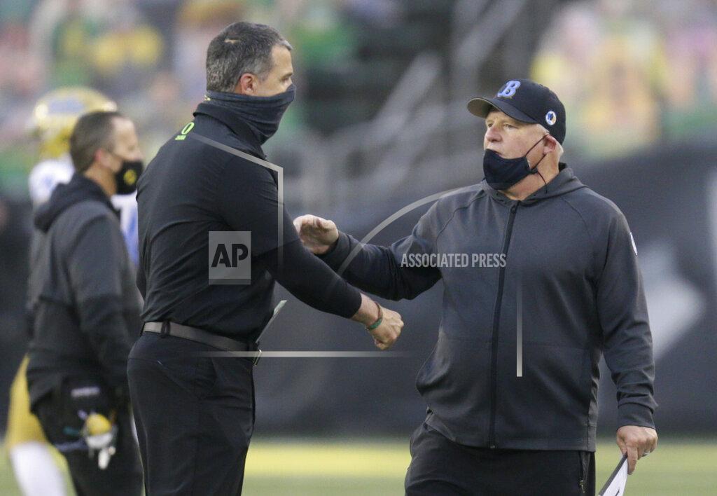 Chris Pietsch Oregon head coach Mario Cristobal, left, and UCLA head coach Chip Kelly meet at midfield after an NCAA college football game Saturday, Nov. 21, 2020, in Eugene, Ore. (AP Photo/Chris Pietsch)