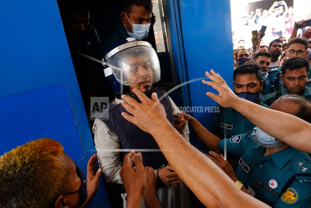 Mahmud Hossain Opu Police escort one of the eight suspected Islamist militants accused of the slayings of two men including a prominent gay rights activist five years ago, towards a court in Dhaka, Bangladesh, Tuesday, Aug. 31, 2021. The court sentenced six of them to death, lawyers said. On Tuesday, judge Mojibur Rahman of the Anti-Terrorism Special Tribunal said six were responsible for the killings of the two and acquitted two others. (AP Photo/Mahmud Hossain Opu)