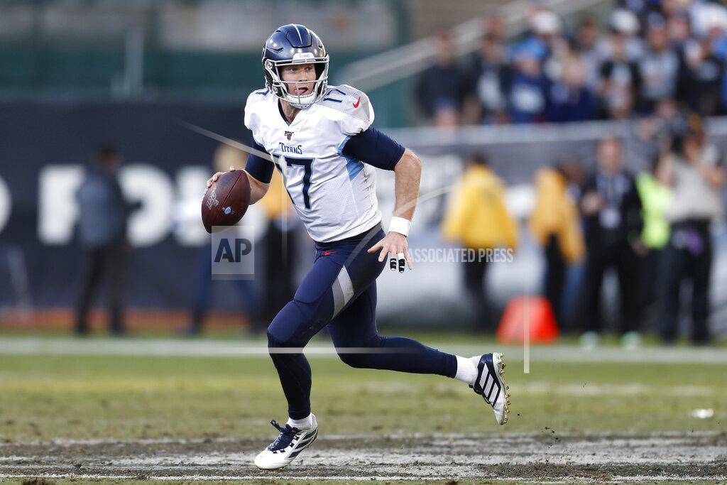 D. Ross Cameron Tennessee Titans quarterback Ryan Tannehill (17) rolls out to pass against the Oakland Raiders during the second half of an NFL football game in Oakland, Calif., Sunday, Dec. 8, 2019. (AP Photo/D. Ross Cameron)