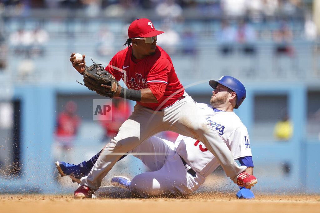 Ashley Landis Philadelphia Phillies second baseman Jean Segura (2) throws to first for a double play during the fourth inning of a baseball game against the Los Angeles Dodgers in Los Angeles, Sunday, May 15, 2022. Los Angeles Dodgers' Max Muncy (13) was out at second and Justin Turner was out at first. (AP Photo/Ashley Landis)