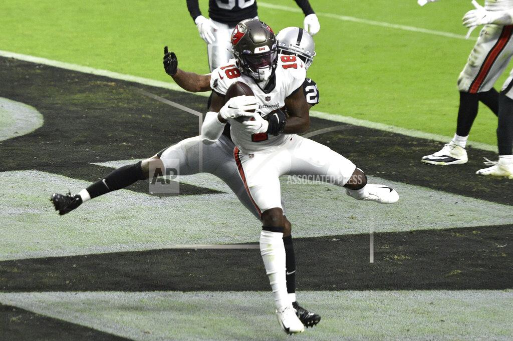 David Becker Tampa Bay Buccaneers wide receiver Tyler Johnson (18) catches a touchdown pass around Las Vegas Raiders cornerback Trayvon Mullen (27) during the second half of an NFL football game, Sunday, Oct. 25, 2020, in Las Vegas. (AP Photo/David Becker)