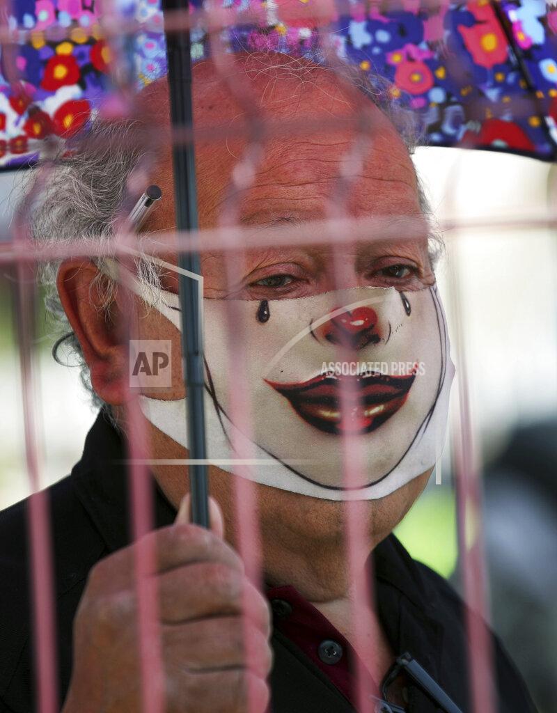 Marco Ugarte An elderly man with a mask painted as a clown, to curb the spread of the new coronavirus waits in line for his dose of the Sinovac Biotech COVID-19 vaccine at the Americas sports center in Ecatepec, a borough on the outskirts of Mexico City, Tuesday, Feb. 23, 2021. (Foto AP/Marco Ugarte