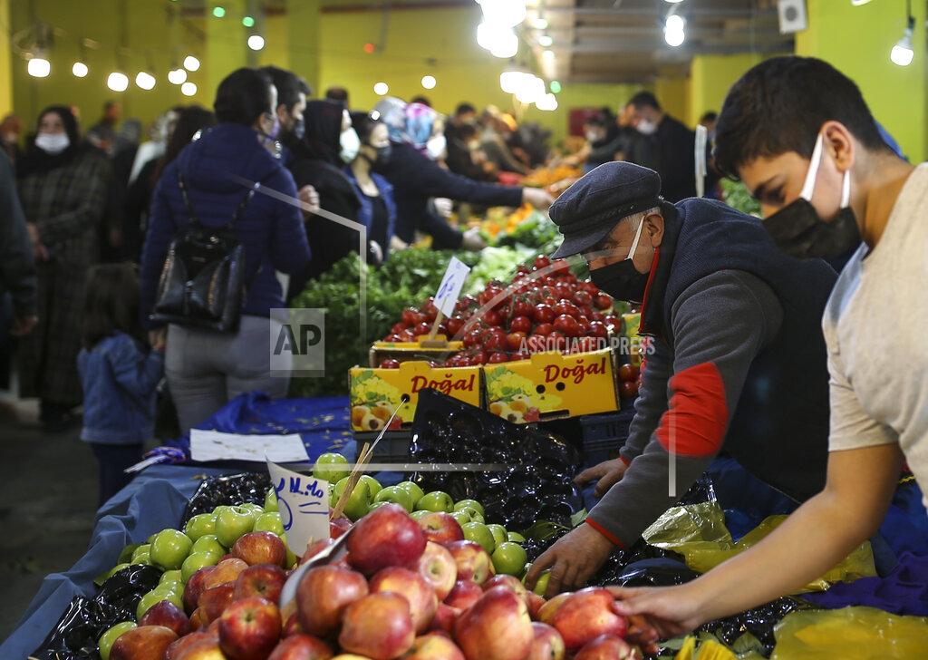 Emrah Gurel People shop at the local market in Istanbul, Thursday, April 29, 2021, a few hours before the start of the latest lockdown to help protect from the spread of the coronavirus. People stocked up on groceries, shoppers filled markets and many left cities for their hometowns or the southern coast as Turkey's strictest COVID-19 lockdown yet came into effect late Thursday. President Recep Tayyip Erdogan imposed a "full lockdown" until May 17 amid soaring COVID-19 infections and deaths. Turkey now ranks among the world's worst-hit countries and it's the first time that it is imposing a nearly three-week lockdown for the whole of the country. (AP Photo/Emrah Gurel)