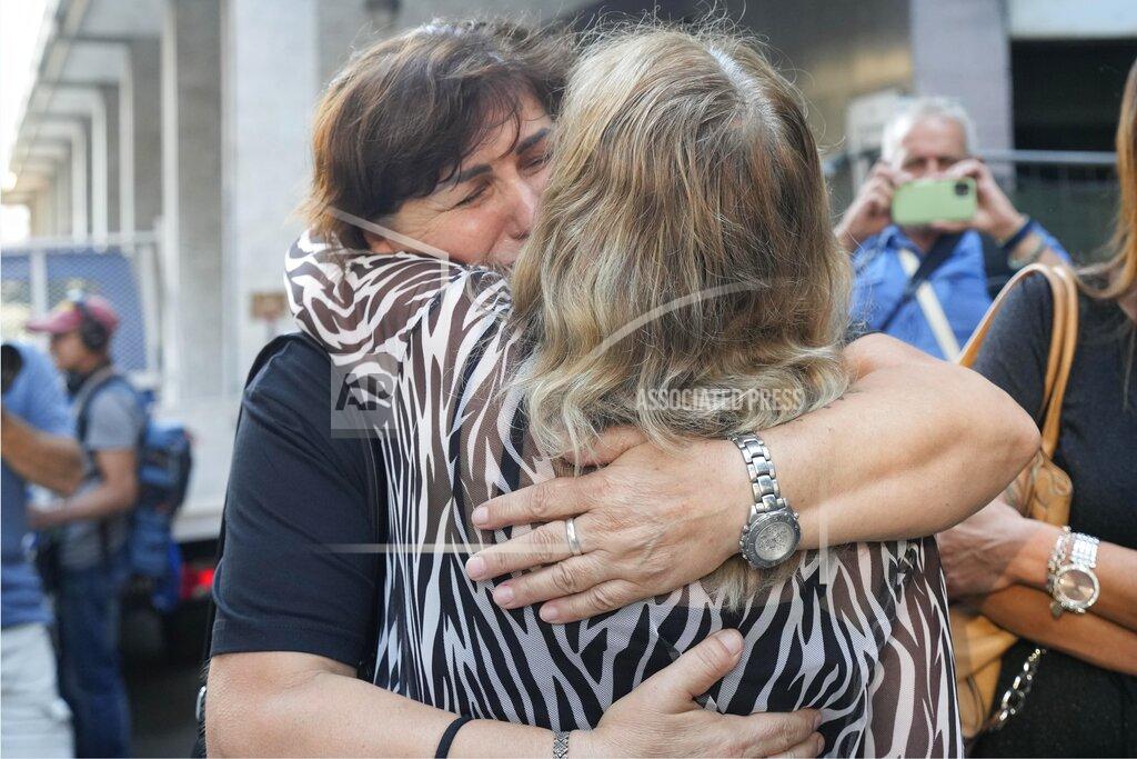 Antonio Calanni Maria Grazia Lonigro, right, and Mimosa Burkina, mothers of Luigi Matti Altadonna and Admir two of the 43 victims greet each other outside the Genoa's Palace of Justice on opening of the first hearing of the trial for the Morandi bridge collapse, Thursday, July 7, 2022. Forty-three people were killed when a large stretch of the Morandi Bridge broke off, August 14, 2018, on the eve of one of Italy's biggest vacation holidays. (AP Photo/Antonio Calanni)