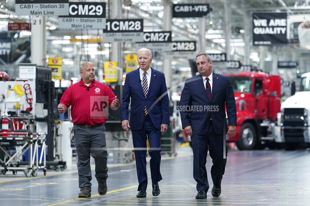 Susan Walsh President Joe Biden walks with Mack Trucks President Martin Weissburg, right, and UAW Local 677 Shop Chairman Kevin Fronheiser, left, during a tour of the Lehigh Valley operations facility for Mack Trucks in Macungie, Pa., Wednesday, July 28, 2021. During his visit, he will advocate for government investments and clean energy as ways to strengthen U.S. manufacturing. (AP Photo/Susan Walsh)