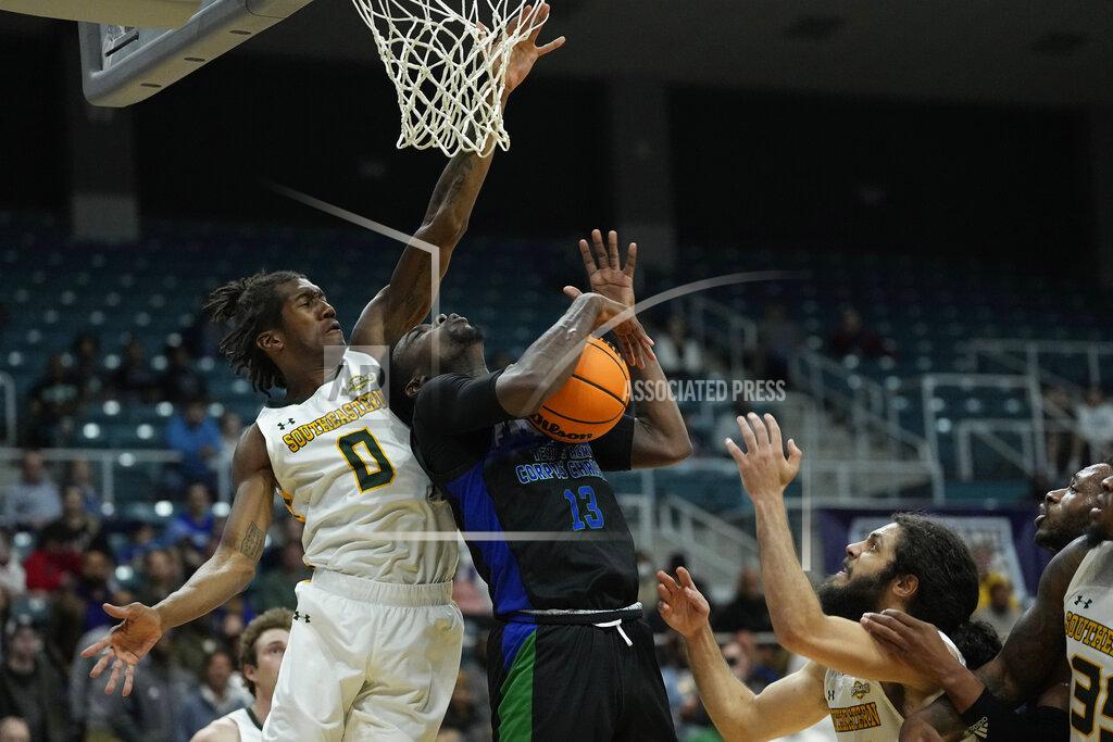 David J. Phillip Texas A&M Corpus Christi's De'Lazarus Keys (13) grabs a rebound in front of Southeastern Louisiana's Jalyn Hinton (0) during the second half of the Southland Conference tournament NCAA college basketball game final Saturday, March 12, 2022, in Katy, Texas. Texas A&M Corpus Christi won 73-65.(AP Photo/David J. Phillip)