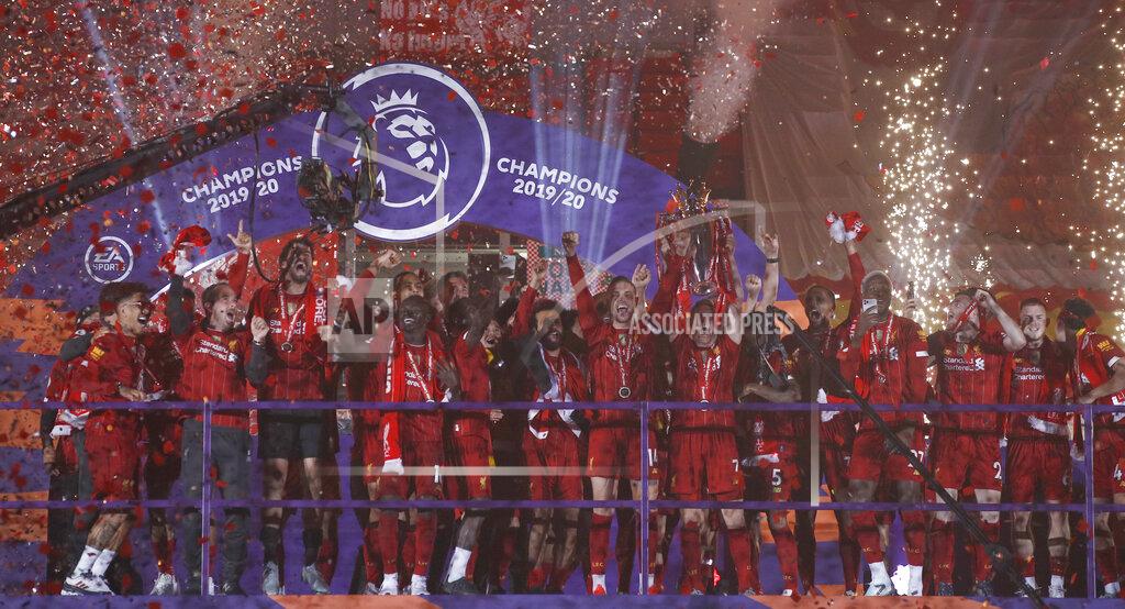 Phil Noble Liverpool's Jordan Henderson lifts the English Premier League trophy following the English Premier League soccer match between Liverpool and Chelsea at Anfield Stadium in Liverpool, England, Wednesday, July 22, 2020. Liverpool are champions of the EPL for the season 2019-2020. The trophy is presented at the teams last home game of the season. Liverpool won the match against Chelsea 5-3. (Phil Noble/Pool via AP)