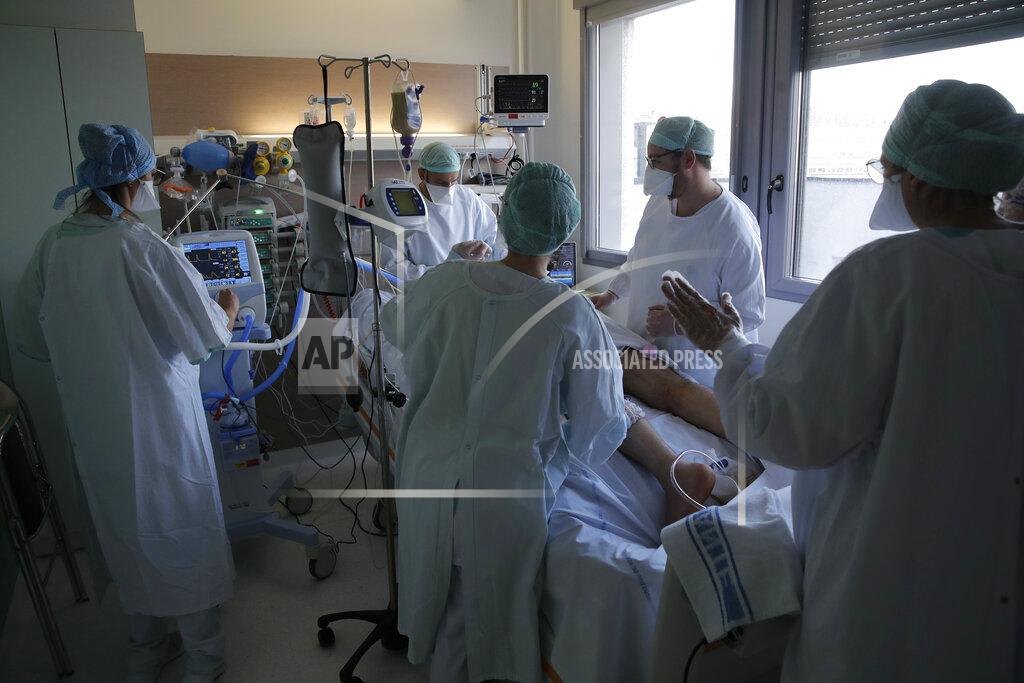 Christophe Ena FILE - In this April 15, 2021, fie photo, medical staff tend to a patient affected by coronavirus in the ICU unit at the Charles Nicolle public hospital in Rouen, Normandy. Hospitals in many European countries are again under strain, treating increasingly younger patients with severe COVID-19 as older age groups benefit from the vaccinations. (AP Photo/Christophe Ena, File)