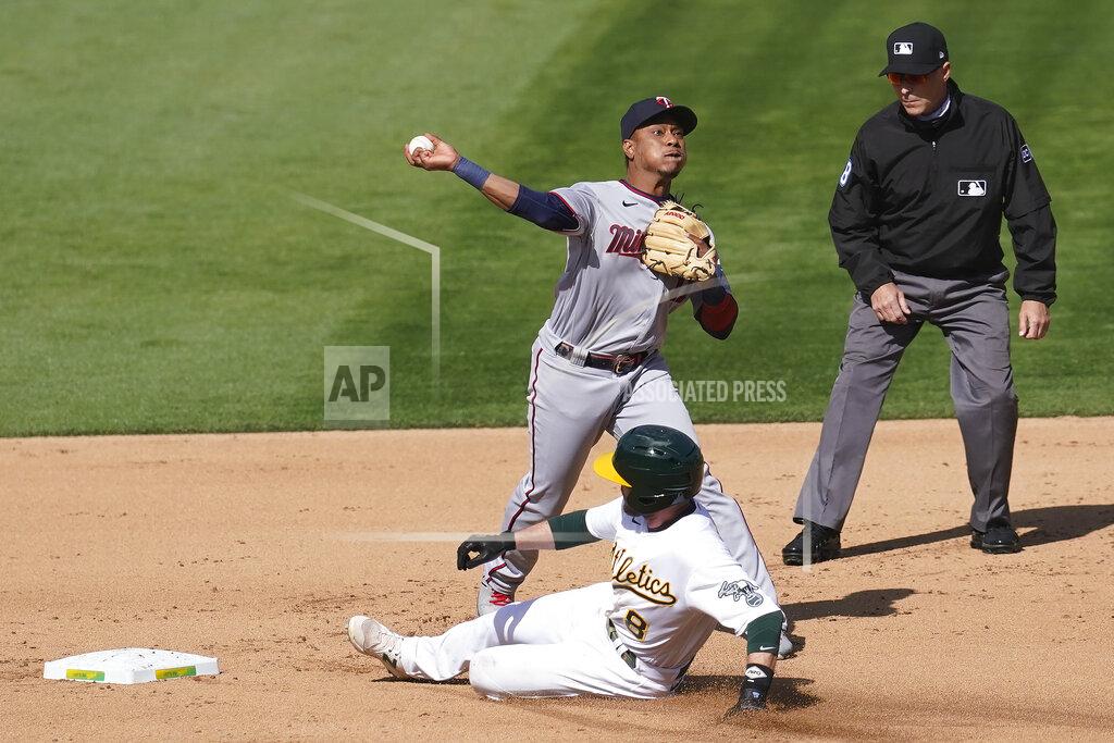 Jeff Chiu Minnesota Twins shortstop Jorge Polanco, top, throws to first base after forcing out Oakland Athletics' Jed Lowrie at second base on a double play hit into by Matt Olson during the third inning of the first baseball game of a doubleheader in Oakland, Calif., Tuesday, April 20, 2021. (AP Photo/Jeff Chiu)
