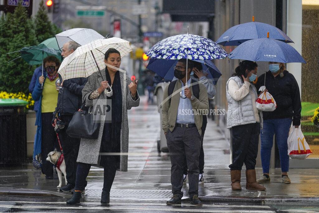 Seth Wenig Pedestrians make their way through a rainy and foggy New York, Tuesday, Oct. 26, 2021. (AP Photo/Seth Wenig)
