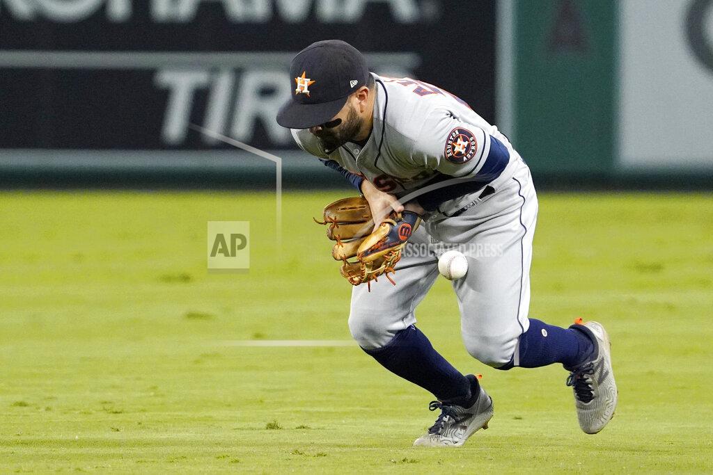 Mark J. Terrill RETRANSMISSION TO CORRECT NAME FROM JACK MAYFIELD TO JOSE ROJAS - Houston Astros second baseman Jose Altuve bobbles a ball hit by Los Angeles Angels' Jose Rojas during the sixth inning of a baseball game Thursday, Sept. 23, 2021, in Anaheim, Calif. Rojas was safe at first on the play and Altuve was charged with an error. (AP Photo/Mark J. Terrill)